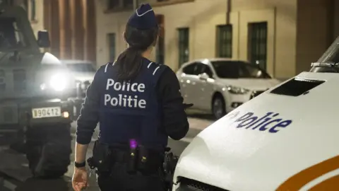 Getty Images A policewoman during an operation in Brussels on 25 August 2017