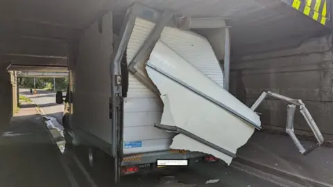 Cambs Police Lorry stuck under bridge