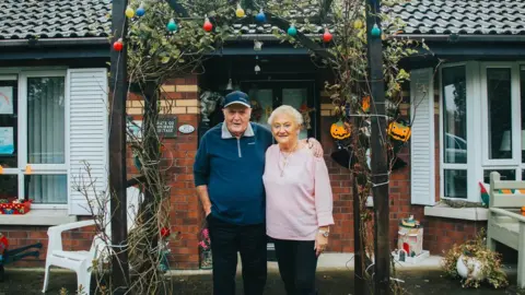 Oliver Grant John and May Carlin smile in their portrait