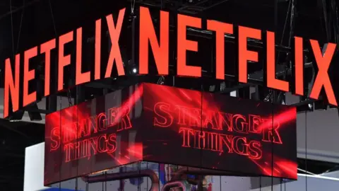 Getty Images The Netflix booth advertises Stranger Things Season 4 on a screen during Comic-Con International in San Diego, California.