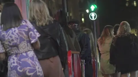 Night clubbers in a queue