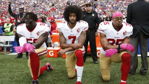 Getty Images Eli Harold, Colin Kaepernick and Eric Reid kneel in protest on October 16, 2016