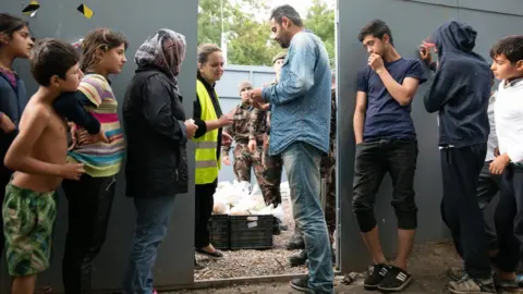 Getty Images Migrants waiting at Hungarian border, 2016 file pic