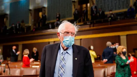 Pool via Getty Images Sen Bernie Sanders (I-VT) arrives before President Joe Biden addresses a joint session of Congress in the House chamber of the U.S. Capitol April 28