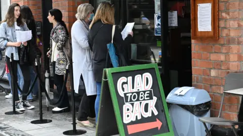 Pacemaker Customers queuing outside a cafe