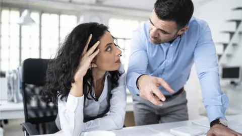 Getty Images Man and woman in office