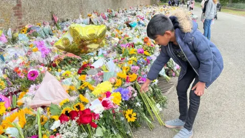 Kate Scotter/BBC Subikshan laying flowers at Sandringham