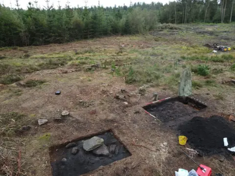 Time Team The excavation site from above, the main standing stone can be seen next to two square areas.