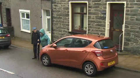 Couple's car outside their home