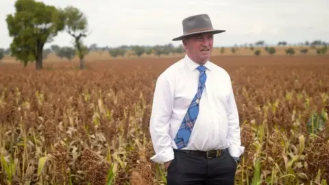 Reuters Barnaby Joyce sands in a paddock in his electorate of New England