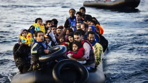 DIMITAR DILKOFFDIMITAR DILKOFF/AFP/Getty Images Migrants arriving by boat at Lesvos