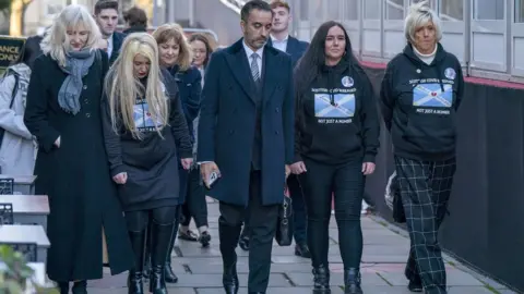 PA Media Scottish bereaved families in Edinburgh for the Scottish inquiry with solicitor Aamer Anwar