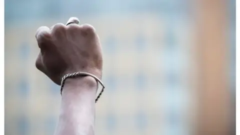 Getty Images A black protester holds up a closed fist in New York