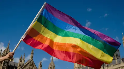 Getty Images pride flags flies with houses of parliament in the background