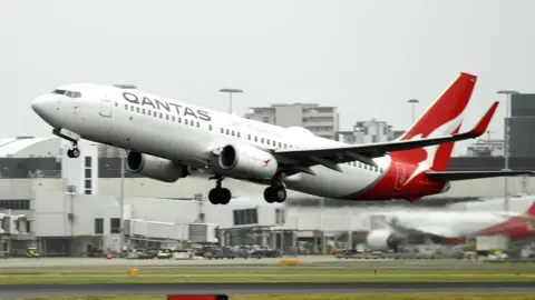 Getty Images A Qantas plane takes off from the Sydney International airport on May 6, 2021