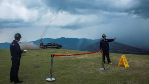 China daily via Reuters A cloud seeding operation taking place in Yichang, Hubei province on 16 August