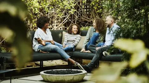 Getty Images Friends seated outdoors