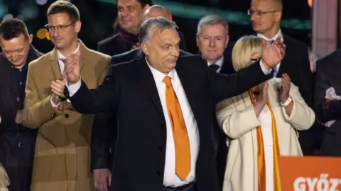 Getty Images Hungarian Prime Minister Viktor Orban acknowledges supporters after the announcement of partial results in the parliamentary election on 3 April 2022 in Budapest, Hungary