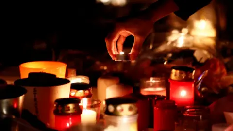 Reuters People light candles in tribute to the victims of the deadly shooting in Strasbourg, France, December 13, 2018.