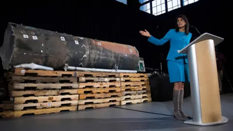 AFP Nikki Haley gestures towards the remnants of a ballistic missile that came close to hitting Riyadh's airport in November, at Joint Base Anacostia in Washington on 14 December 2017