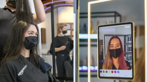 Amazon A woman at the Amazon salon and an example of the augmented reality mirror