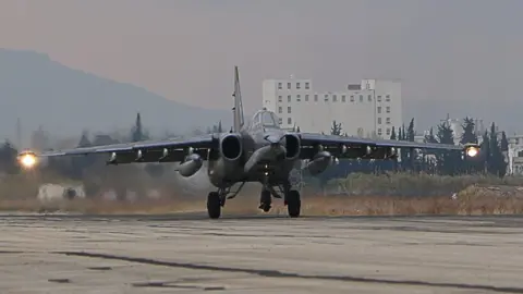 Getty Images A Russian bomber lands at the Russian Hmeimim military base in Latakia province, in the northwest of Syria, 16 December 2015