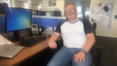 Admiral Ellis Cockram sitting at a desk