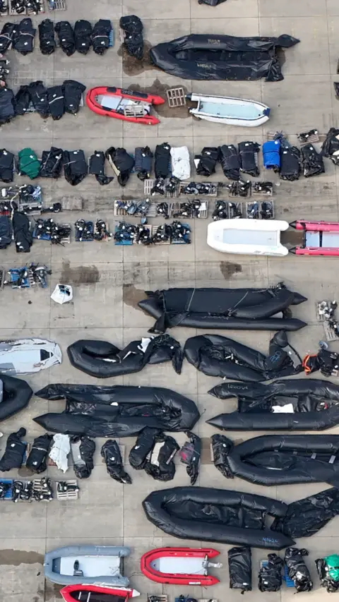 An aerial view of small boats on land.