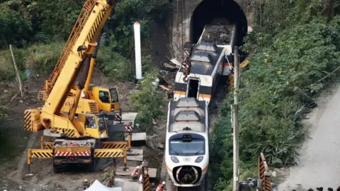 EPA Salvage crews remove train carriages north of Hualien, Taiwan, 3 April 2021