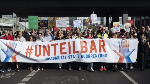 EPA Marchers carry "#indivisible" banner