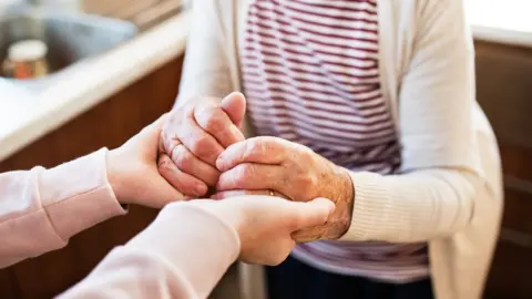 Getty Images Helping a person with learning disabilities