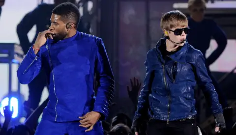 Getty Images Usher and Justin Bieber on stage