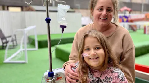 Nikki Fox/BBC Ella and mum Kelly Gilbert