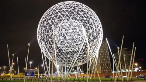 Paul McErlane Spherical metal sculpture at night