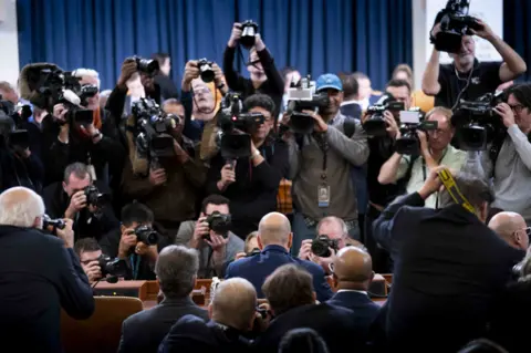 Getty Images Gordon Sondland at hearing surrounded by cameras