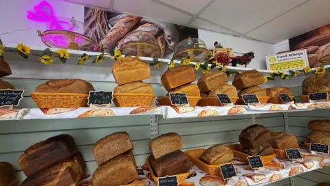 Shelves full of bread inside a bakery