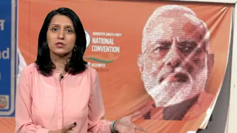 BBC correspondent Yogita Limaye in front of a Modi poster