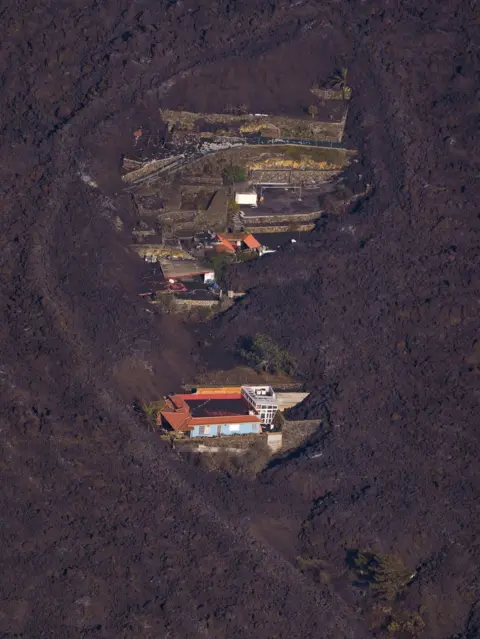 Reuters Houses surrounded by lava on the island of La Palma