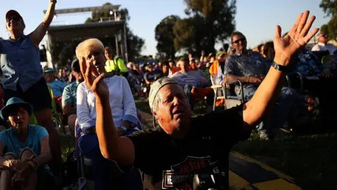 Justin Sullivan Attendees sing during Franklin Graham's "Decision America" California tour at the Stanislaus County Fairgrounds on May 29, 2018 in Turlock, California.