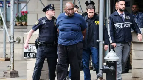 Getty Images Frank James is apprehended by police on 13 April