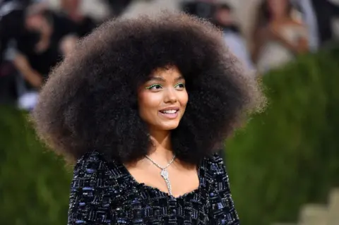 AFP Whitney Peak poses on the red carpet.