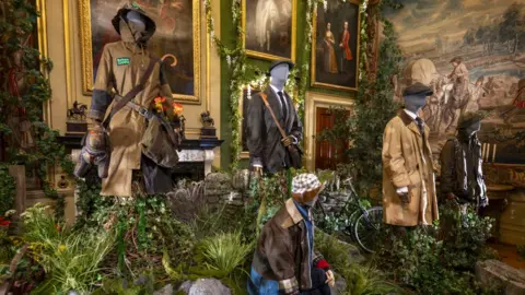 Pete Seaward male mannequins sitting in shrubbery