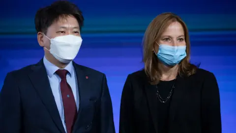 Getty Images General Motors CEO Mary Barra poses for a photo with Dong Myung Kim, LG Energy Solution Head of Advanced Automotive Battery Division at an event.