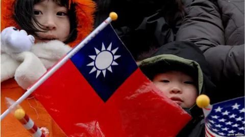 Getty Images A child holds the ROC flag during a parade in DC's Chinatown.