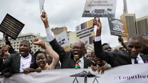 AFP Kenyan advocates hold placards during a picket following a protest call to members by the Law Society of Kenya against recent remarks by Kenya's President, William Ruto, accusing the judiciary of wide spread corruption and lacking in integrity, in the Central Business District in Nairobi on January 12, 2024.