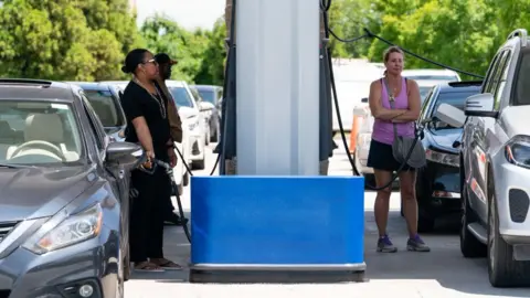 Getty Images Customers queuing to fill up their cars on 11 May.