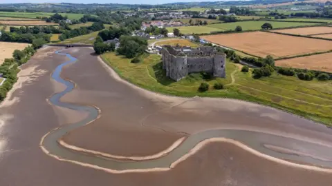 Getty Images An aerial view during low tide in the Carew River which runs alongside Carew Castle