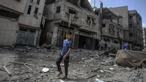 Anadolu Agency A child walks through rubble in Gaza
