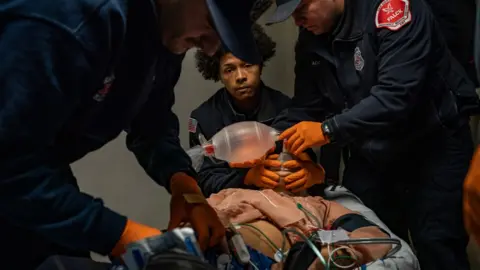 Getty Images Paramedics try to save a woman in San Diego after an overdose