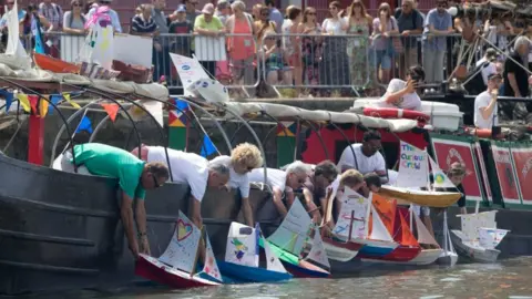 Bristol Harbourside Festival People setting off their carboard boats in the competition